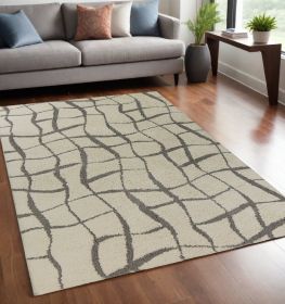 5' X 7' Ivory Machine Woven Abstract Indoor Shag Rug